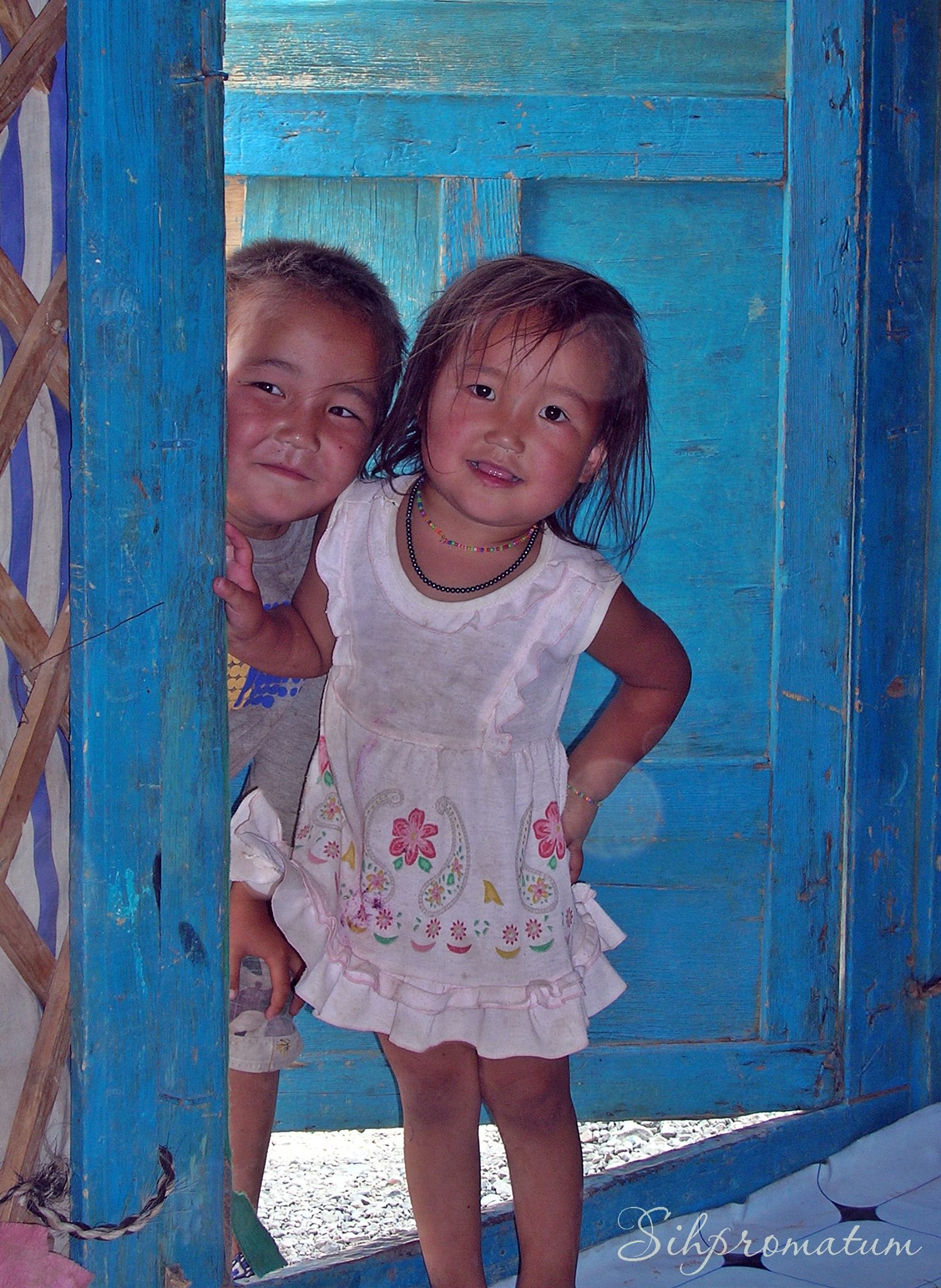 Adorable-shy-Mongolian-children-peeking-into-our-ger-in-the-countryside.